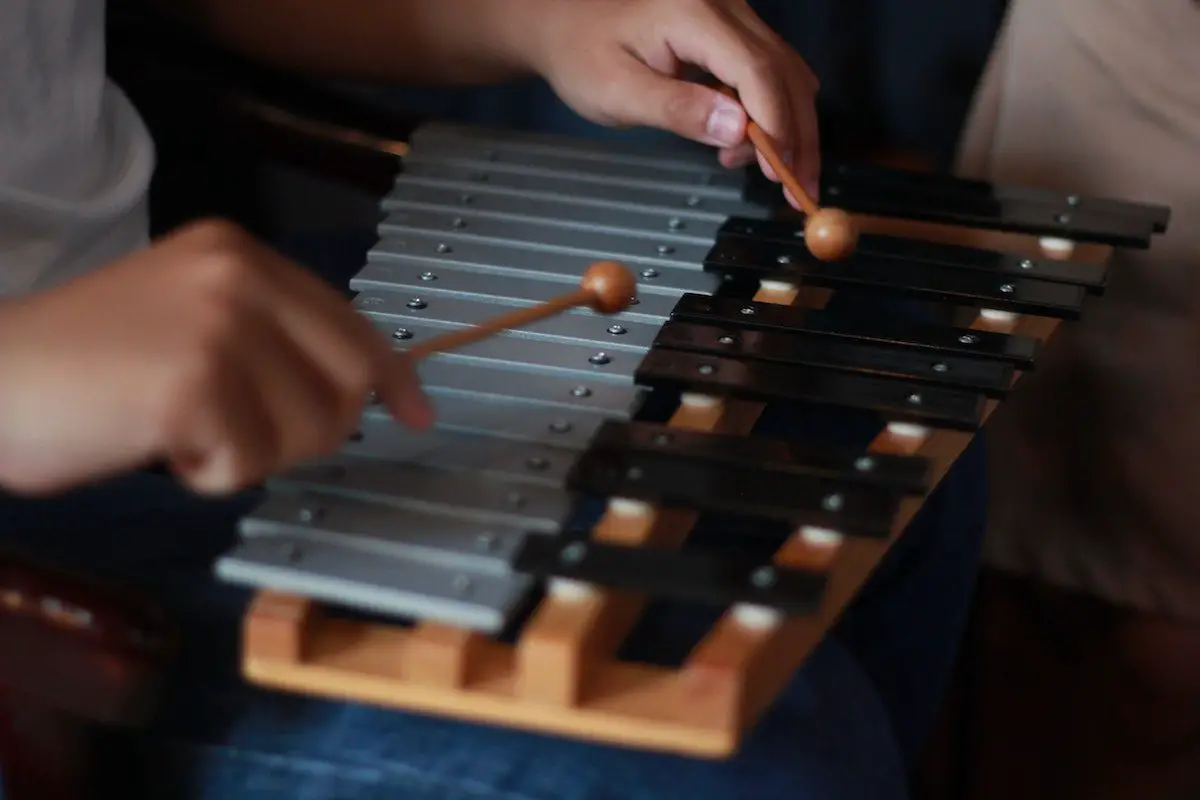 Image of a person playing with a glockenspiel. Source: pexels