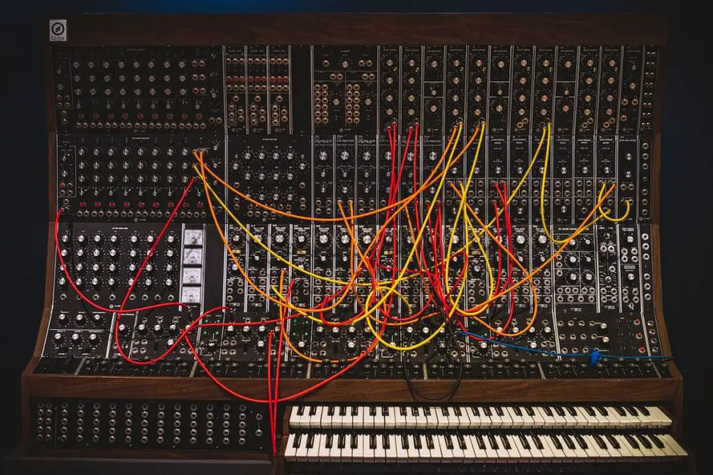 Image of synthesizer with patch cables connected unsplash