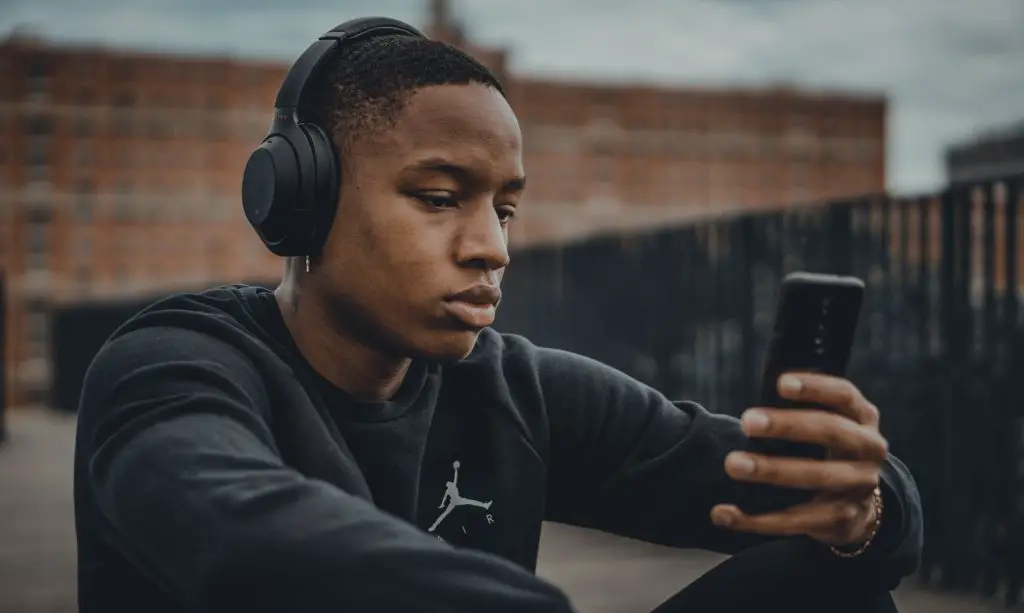 Man wearing wireless headphones and listening to music. Source: unsplash