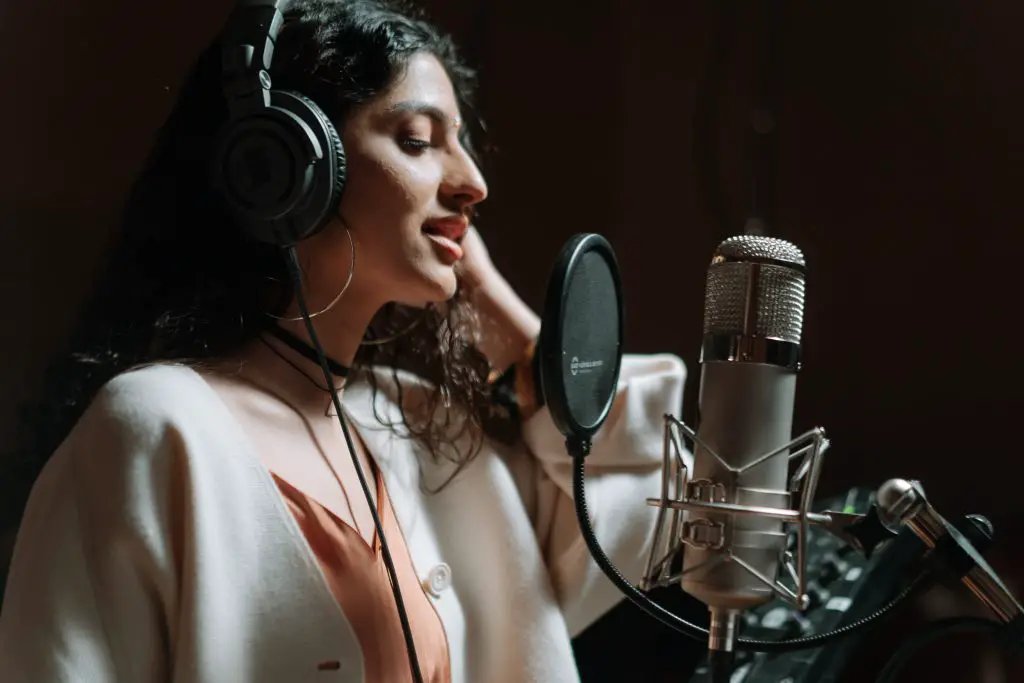Woman recording in a studio. Source: pexels