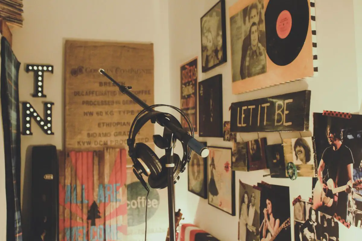 Image of a home studio with a headphone hanged on a stand.