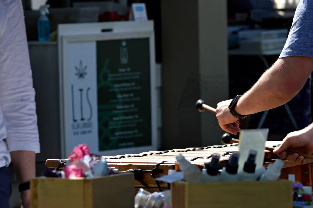 Image of a musician playing the marimba outside.