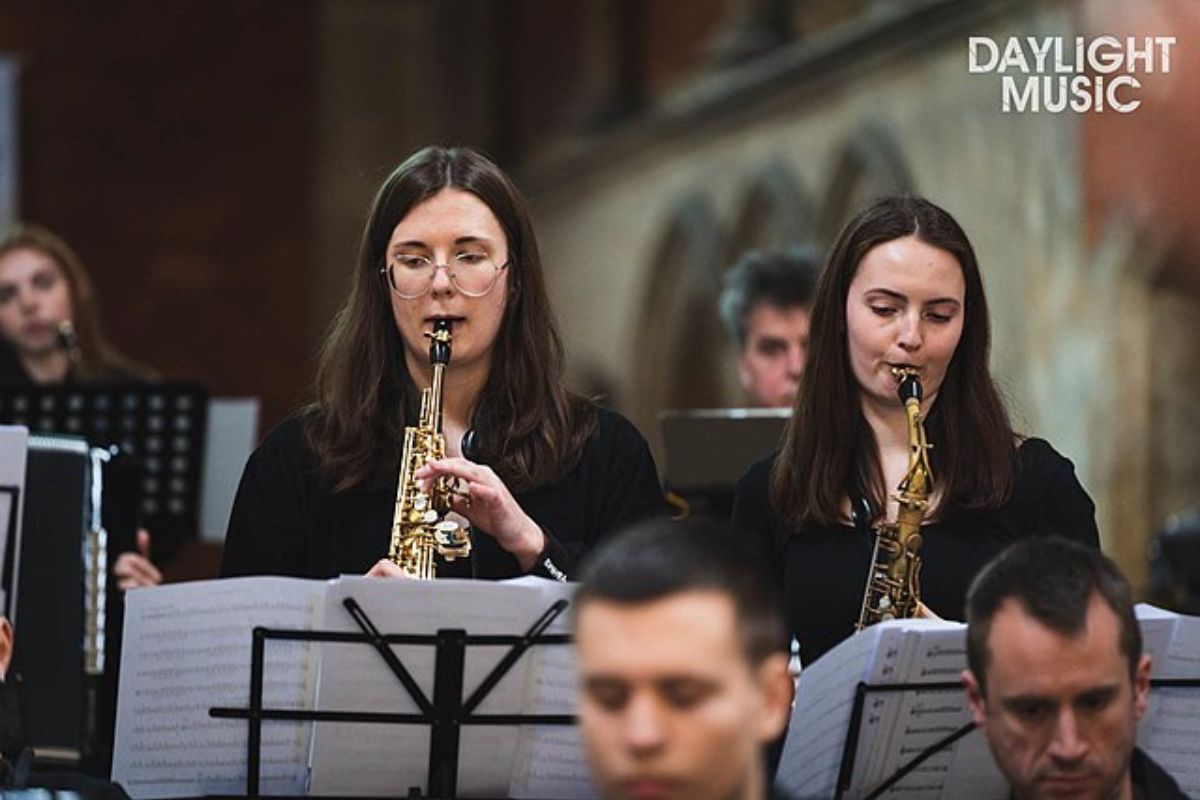 Image of an orchestra performing with saxophone ensemble.