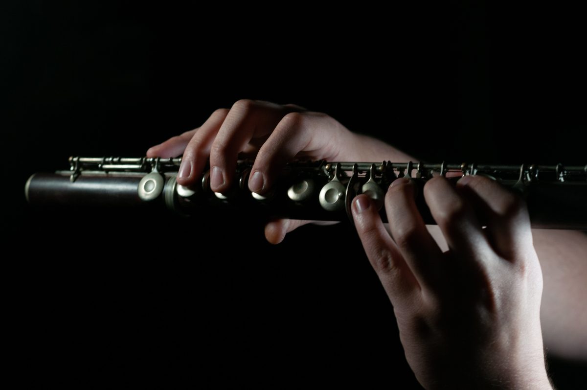 Image of someone holding and playing a flute.
