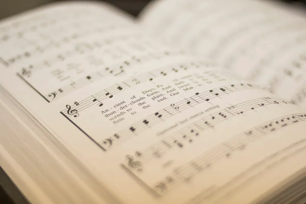 A closeup of an open book with music notation. Source: unsplash