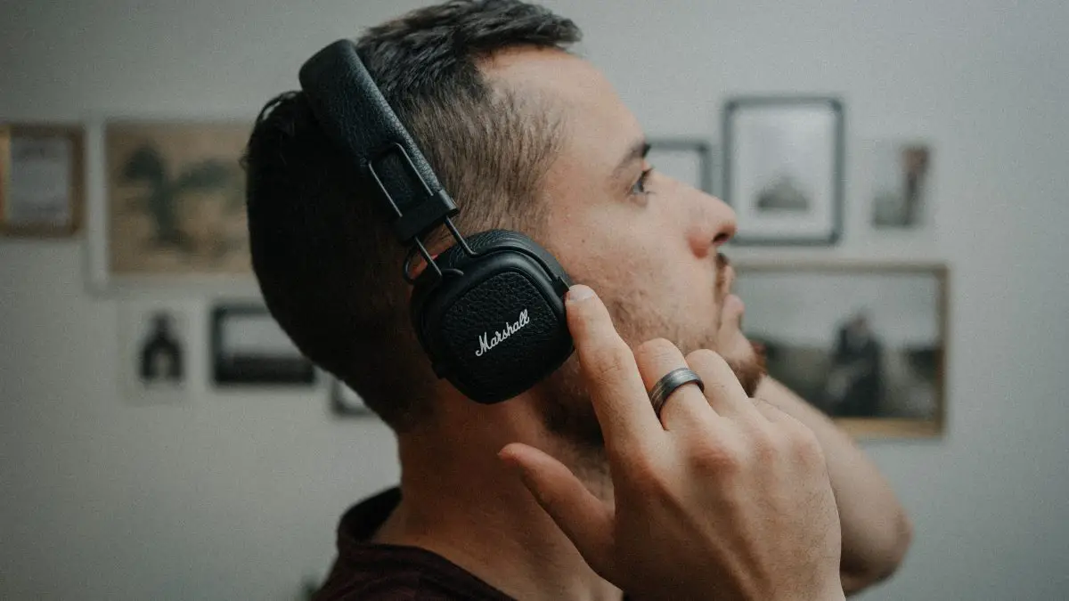 A man with headphones listening to music. Source: unsplash