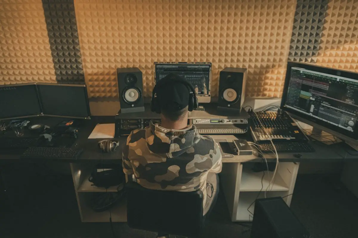 An audio engineer working in a home studio. Source: unsplash