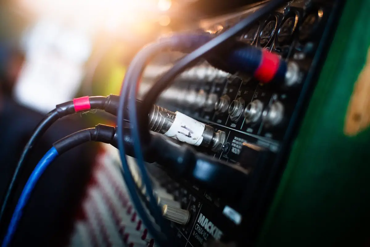 Closeup of audio cables connected in a mixer. Source: unsplash