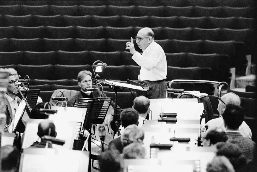 Igor stravinsky in front of an orchestra. Source: wikicommons