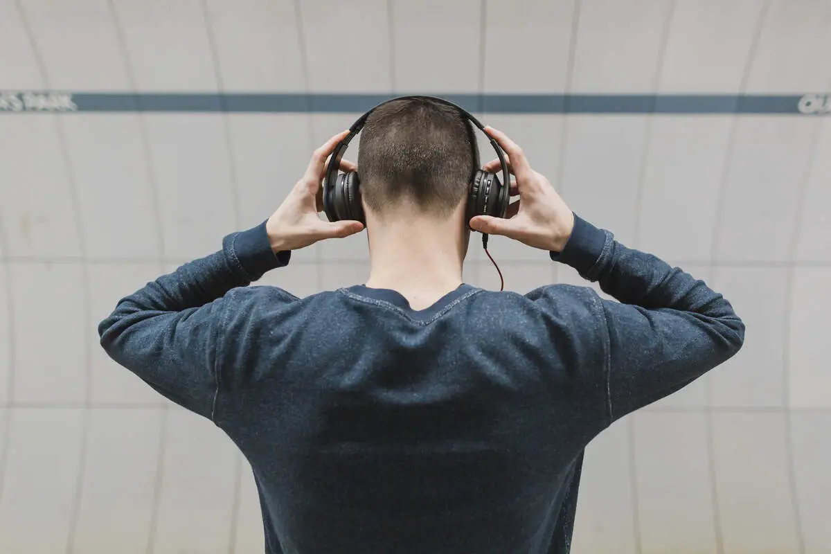 Image of a man listening to music with his headphones. Source: burst