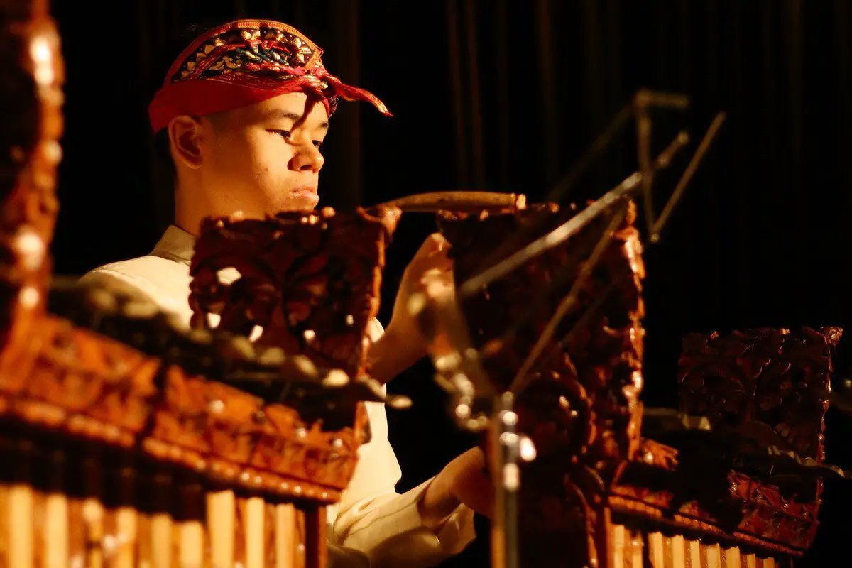 Image of a man playing a gamelan instrument. Source: unsplash