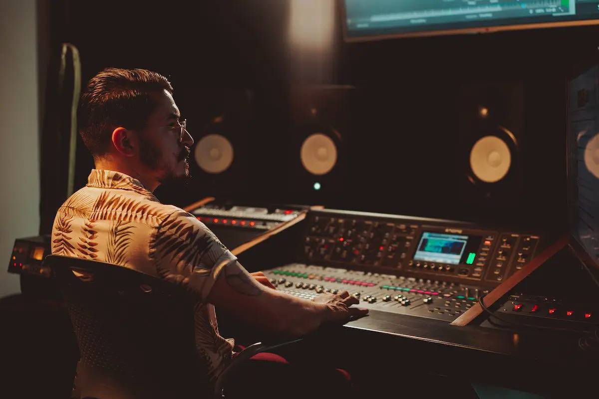 Image of a music engineer in a studio. Source: pexels