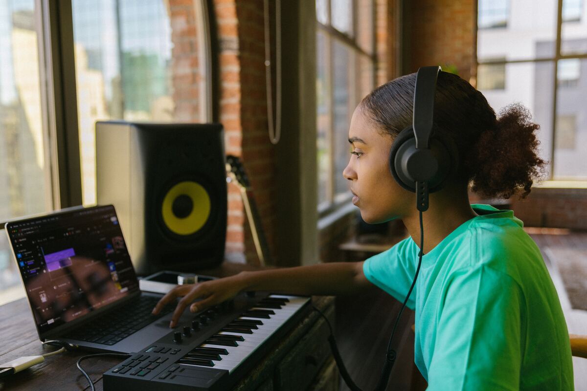 Image of a music producer listening to the rhythm of music in a daw. Source: unsplash