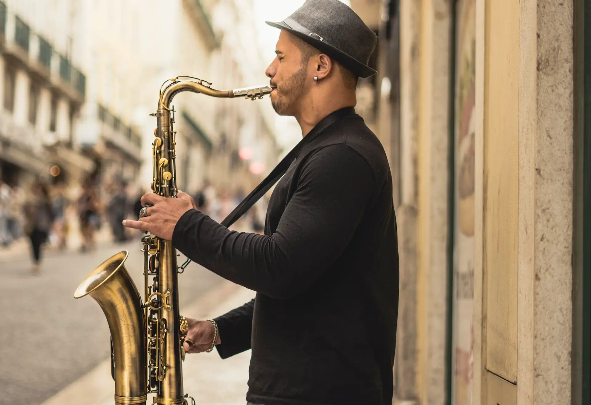 Image of a musician playing the saxophone on the streets. Source: unsplash