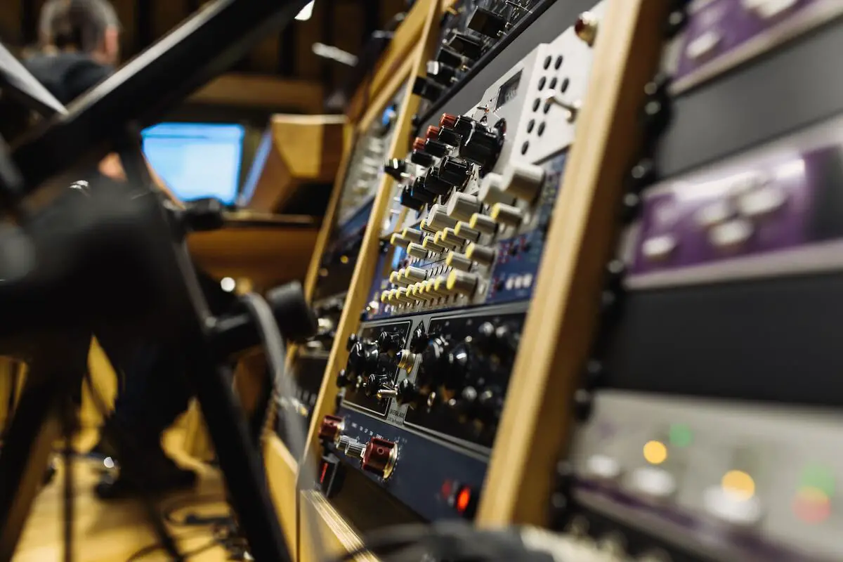 Image of a rack with equipment in a music studio. Source: unsplash