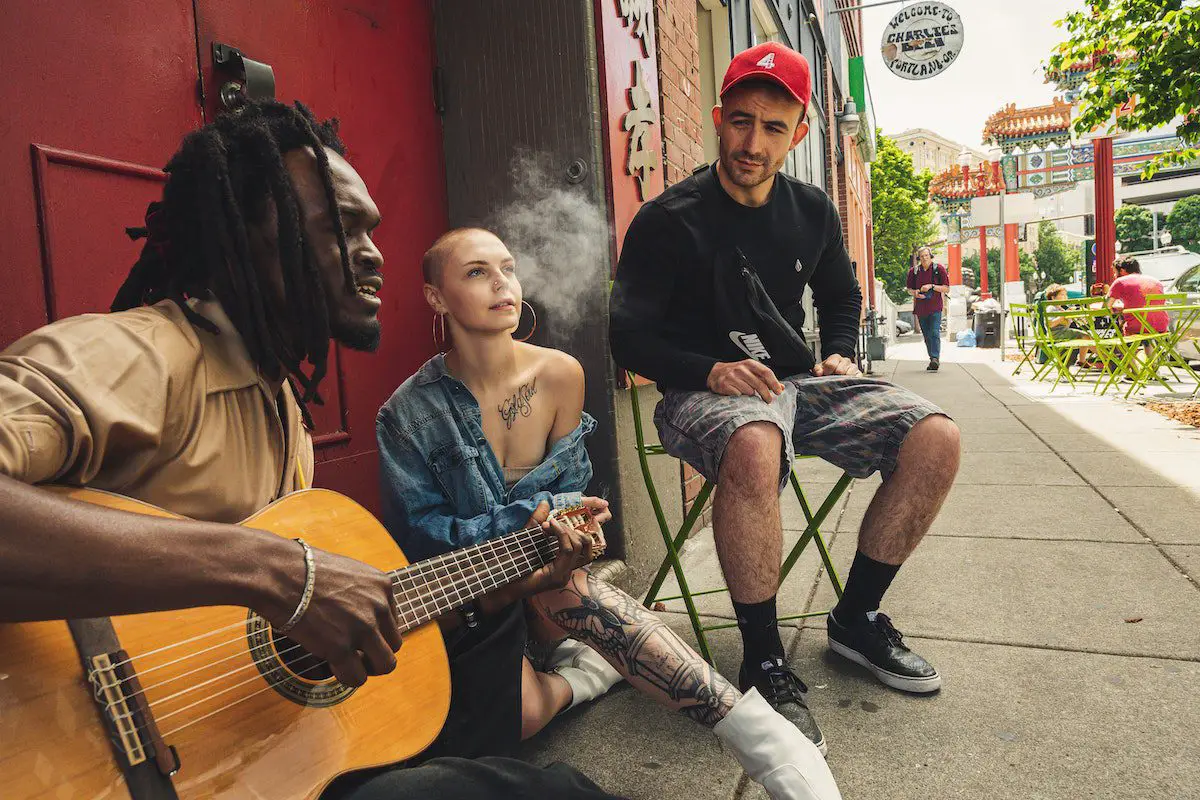 Image of three musicians having a jam session in the streets. Source: pexels