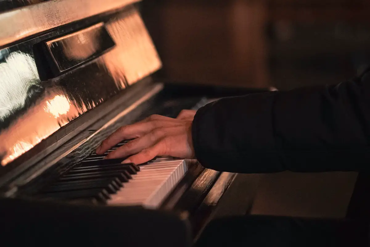 Image of a pianist playing the piano. Source: Unsplash